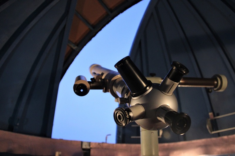 Telescope inside observatory pointing towards the sky
